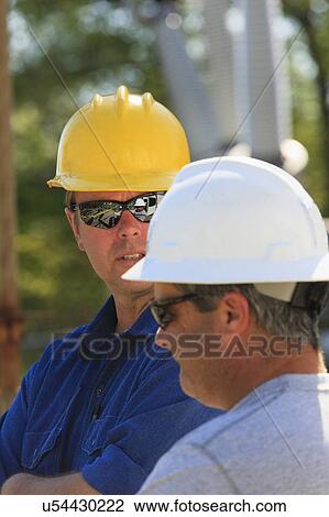 Stock Image - Power engineers at work. Fotosearch
