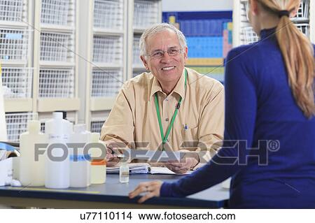 Professor with a student in chemical laboratory View Large Photo Image Picture - Professor with a student in chemical laboratory. Fotosearch