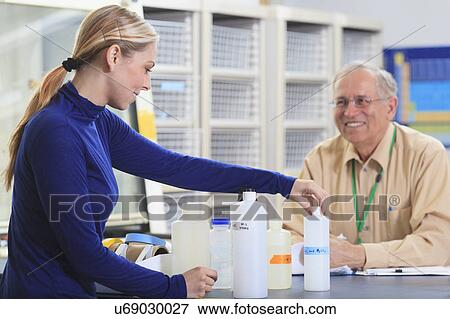 Stock Photo - Professor with a student in chemical laboratory. Fotosearch