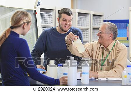 Picture - Professor with students in chemical laboratory. Fotosearch