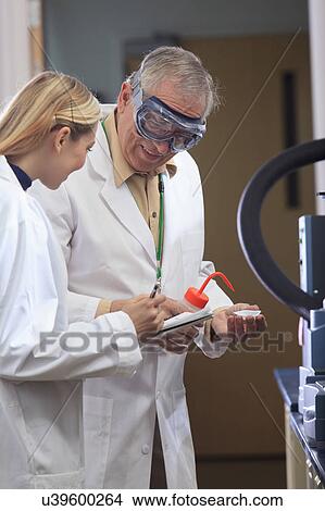 Picture - Professor working with engineering student. Fotosearch