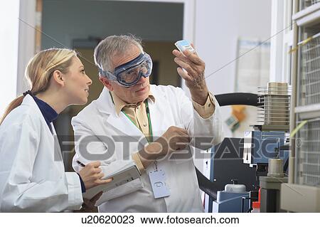 Stock Image - Professor working with engineering student. Fotosearch