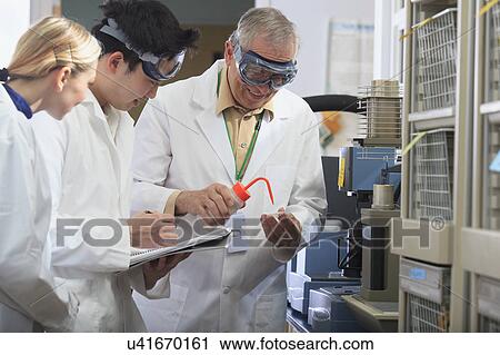 Stock Image - Professor working with engineering student. Fotosearch
