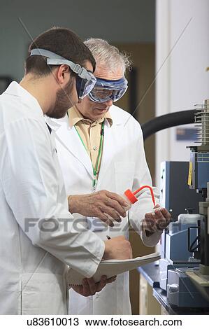 Stock Image - Professor working with engineering student. Fotosearch