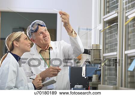 Stock Photo - Professor working with engineering student. Fotosearch