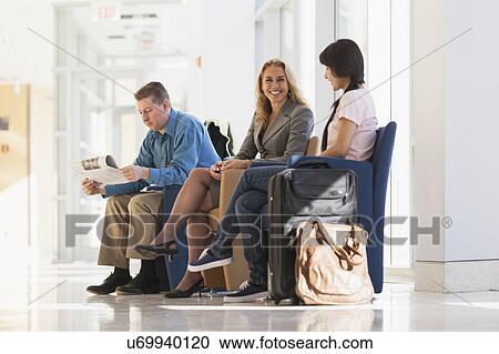 Three passengers waiting in an airport lounge View Large Photo Image Stock Image - Three passengers waiting in an airport lounge. Fotosearch