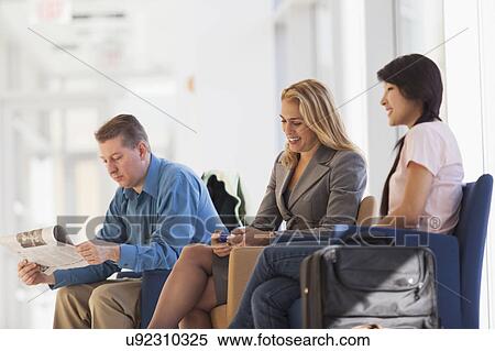 Three passengers waiting in an airport lounge View Large Photo Image Stock Photography - Three passengers waiting in an airport lounge. Fotosearch