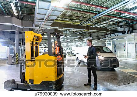 Apprentice engineer with forklift truck in car factory View Large Photo Image Stock Photo - Apprentice engineer with forklift truck in car factory. Fotosearch