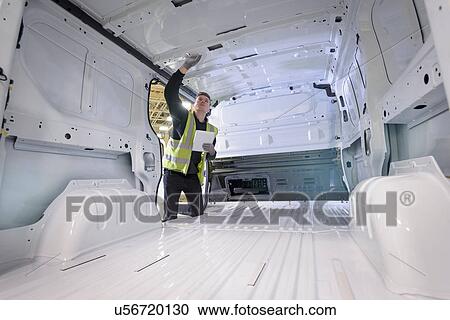 Apprentice vehicle inspector inspecting interior of vehicle in car factory View Large Photo Image Stock Image - Apprentice vehicle inspector inspecting interior of vehicle in car factory. Fotosearch