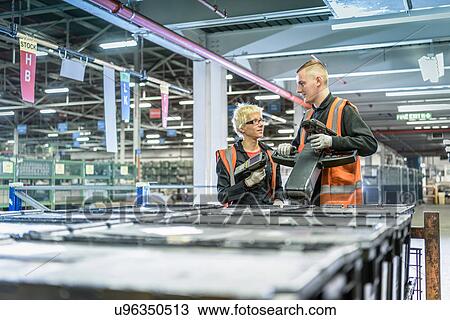 Apprentices in parts store in car factory View Large Photo Image Stock Image - Apprentices in parts store in car factory. Fotosearch