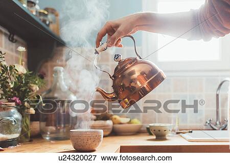 Arm of man pouring boiling water into bowl in kitchen View Large Photo Image Stock Photo - Arm of man pouring boiling water into bowl in kitchen. Fotosearch
