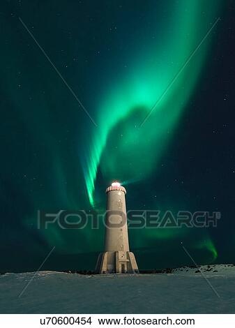 Picture - Aurora borealis swirling green over lighthouse at night, Akranes, Iceland. Fotosearch