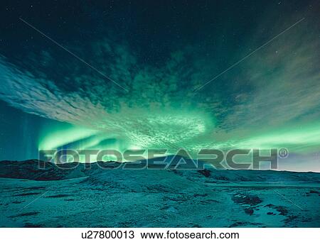 Aurora borealis swirling green over snow covered landscape, Lake Kleifarvatn, Iceland View Large Photo Image Stock Image - Aurora borealis swirling green over snow covered landscape, Lake Kleifarvatn, Iceland. Fotosearch