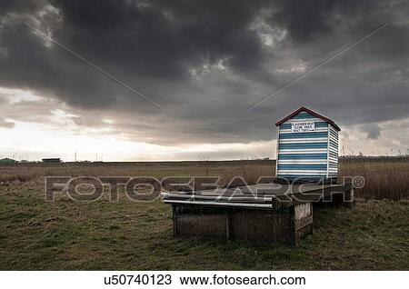 Stock Image - Beach hut with notice promoting boat trips, Aldeburgh, Suffolk, England. Fotosearch
