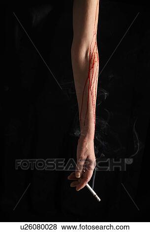 Bleeding arm holding cigarette View Large Photo Image Stock Photo - Bleeding arm holding cigarette. Fotosearch