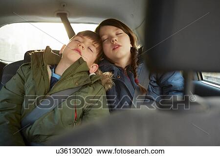 Boy and sister asleep in car backseat View Large Photo Image Stock Image - Boy and sister asleep in car backseat. Fotosearch