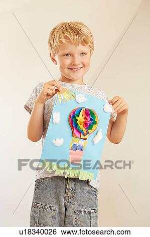 Stock Photograph - Boy holding up hot air balloon collage. Fotosearch