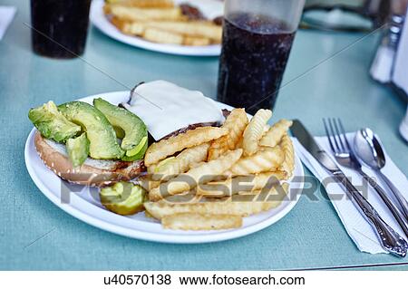 Burger and chips with cola on cafe table, New York City, USA View Large Photo Image Stock Photo - Burger and chips with cola on cafe table, New York City, USA. Fotosearch
