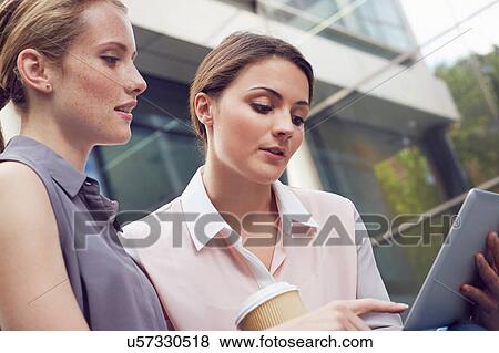 Stock Photo - Business women having discussion on coffee break, London, UK. Fotosearch