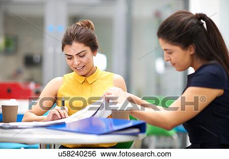 Business women with paperwork in meeting View Large Photo Image Stock Photograph - Business women with paperwork in meeting. Fotosearch