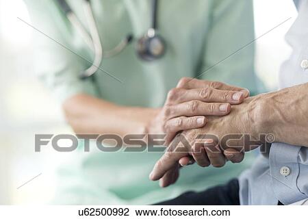 Care worker holding senior man's hand View Large Photo Image Stock Image - Care worker holding senior man's hand. Fotosearch