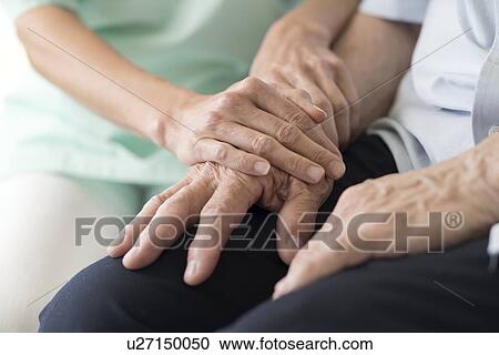 Care worker holding senior man's hands View Large Photo Image Stock Image - Care worker holding senior man's hands. Fotosearch