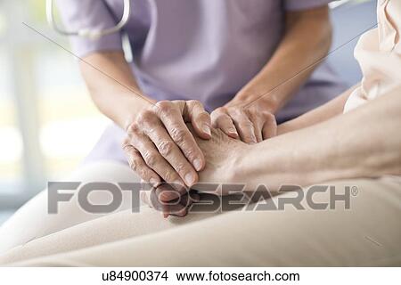 Care worker holding senior woman's hands View Large Photo Image Picture - Care worker holding senior woman's hands. Fotosearch