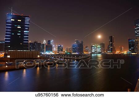 Stock Photograph - Cityscape at night showing Dubai Canal, Dubai, UAE. Fotosearch