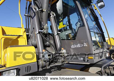 Stock Photo - Close up of earth mover cab on construction site. Fotosearch