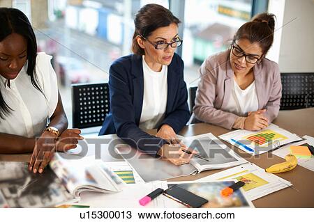 Colleagues having meeting at conference room table View Large Photo Image Stock Image - Colleagues having meeting at conference room table. Fotosearch