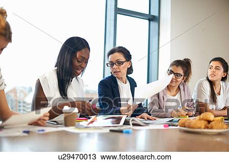 Colleagues having meeting at conference room table View Large Photo Image Stock Image - Colleagues having meeting at conference room table. Fotosearch