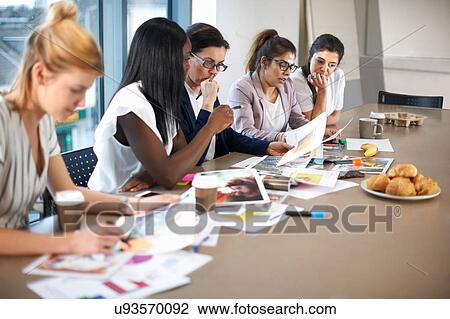 Colleagues having meeting at conference room table View Large Photo Image Stock Image - Colleagues having meeting at conference room table. Fotosearch