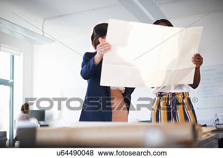 Colleagues in office looking at blueprint View Large Photo Image Stock Photo - Colleagues in office looking at blueprint. Fotosearch