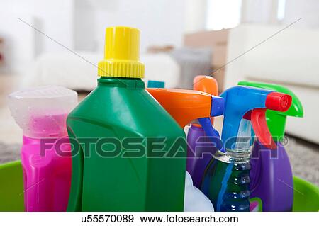 Stock Photo - Colourful cleaning product plastic bottles and sprays on kitchen counter. Fotosearch