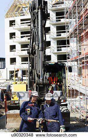 Stock Photo - Construction workers on site. Fotosearch