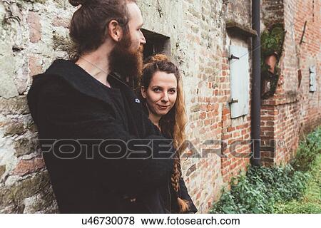 Couple leaning against old brick farm building View Large Photo Image Stock Photo - Couple leaning against old brick farm building. Fotosearch