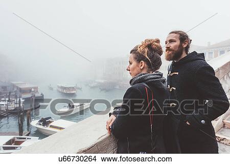 Couple looking out over misty canal, Venice, Italy View Large Photo Image Picture - Couple looking out over misty canal, Venice, Italy. Fotosearch
