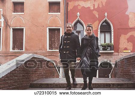 Couple moving down canal bridge, Venice, Italy View Large Photo Image Stock Photography - Couple moving down canal bridge, Venice, Italy. Fotosearch