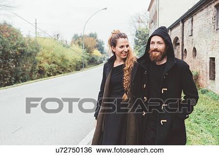 Stock Photograph - Couple strolling along rural road. Fotosearch