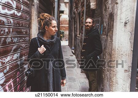 Picture - Couple with camera in alley, Venice, Italy. Fotosearch
