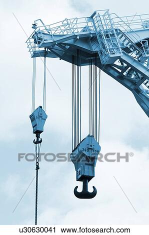 Stock Image - Crane hooks on construction site. Fotosearch