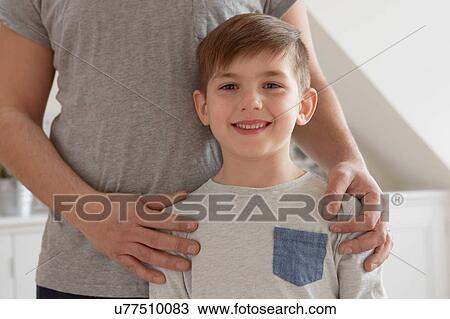 Cropped portrait of boy with father's hands on shoulders View Large Photo Image Stock Image - Cropped portrait of boy with father's hands on shoulders. Fotosearch