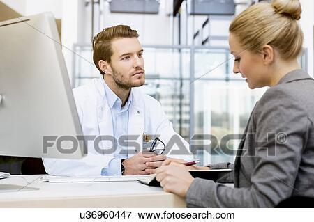 Stock Photo - Doctor in meeting with consultant. Fotosearch