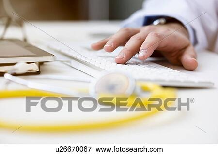 Doctor using computer, tying on keyboard, close-up View Large Photo Image Stock Photo - Doctor using computer, tying on keyboard, close-up. Fotosearch