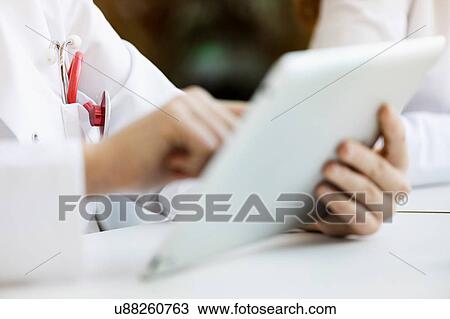Doctor using digital tablet, close-up View Large Photo Image Stock Image - Doctor using digital tablet, close-up. Fotosearch