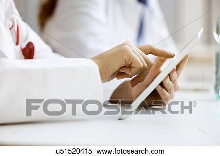 Doctor using digital tablet, close-up View Large Photo Image Stock Photography - Doctor using digital tablet, close-up. Fotosearch