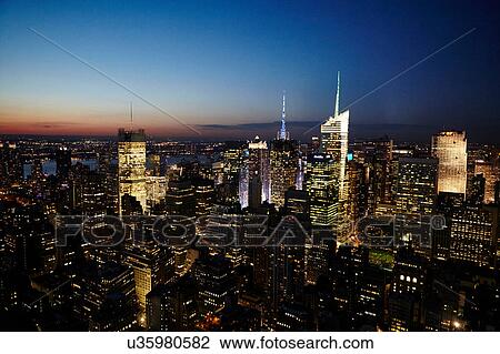 Stock Image - Elevated view of skyline at night with Empire State Building, New York City, USA. Fotosearch