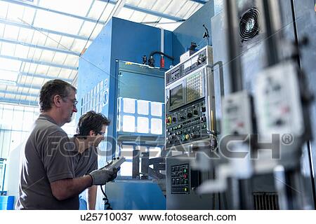 Engineer and apprentice operating lathe in precision casting factory View Large Photo Image Stock Photo - Engineer and apprentice operating lathe in precision casting factory. Fotosearch