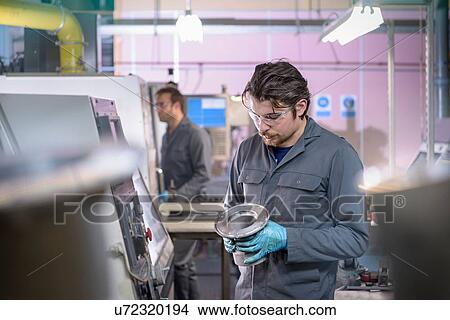 Engineer finishing aluminium component in precision casting factory View Large Photo Image Picture - Engineer finishing aluminium component in precision casting factory. Fotosearch