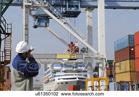 Stock Image - Engineer on site at shipping port. Fotosearch